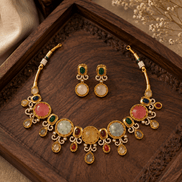 Gold-tone necklace and earrings set with round gemstone drops and oval center stones