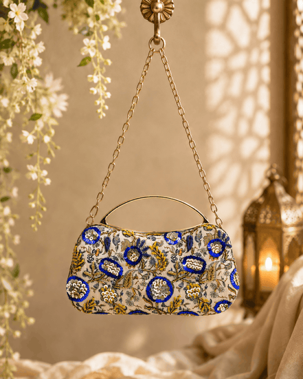 Beige floral clutch bag with blue and gold medallion pattern and chain handle