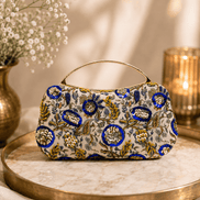 Beige floral clutch bag with blue and gold ornaments and curved top handle
