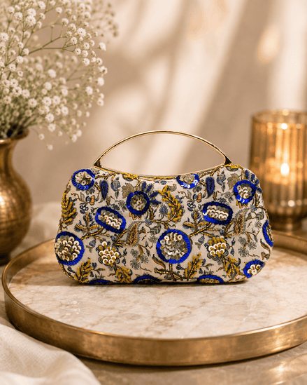Beige floral clutch bag with blue and gold ornaments and curved top handle