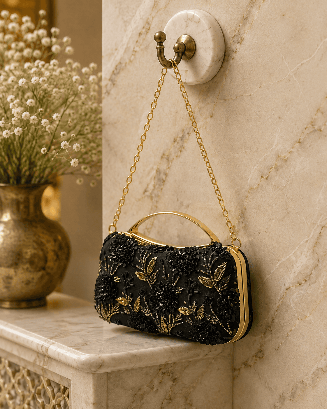 Black fabric floral clutch bag with gold embroidered flowers and top handle