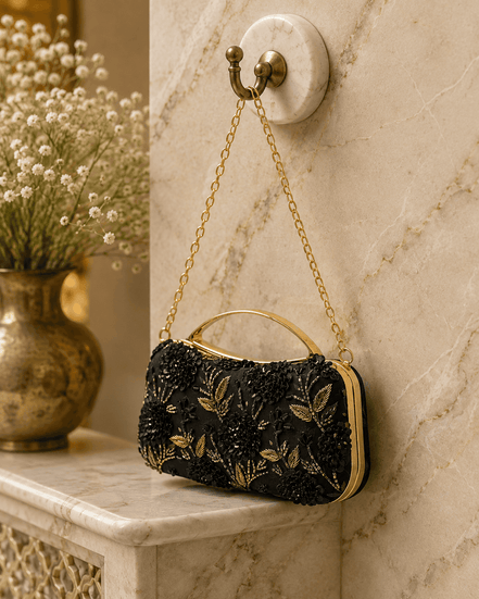 Black fabric floral clutch bag with gold embroidered flowers and top handle