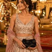 Black floral clutch bag with gold embroidered pattern, held in hands