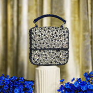 Blue crystal box bag with top handle and hinged clasp, sparkling rhinestone front panel