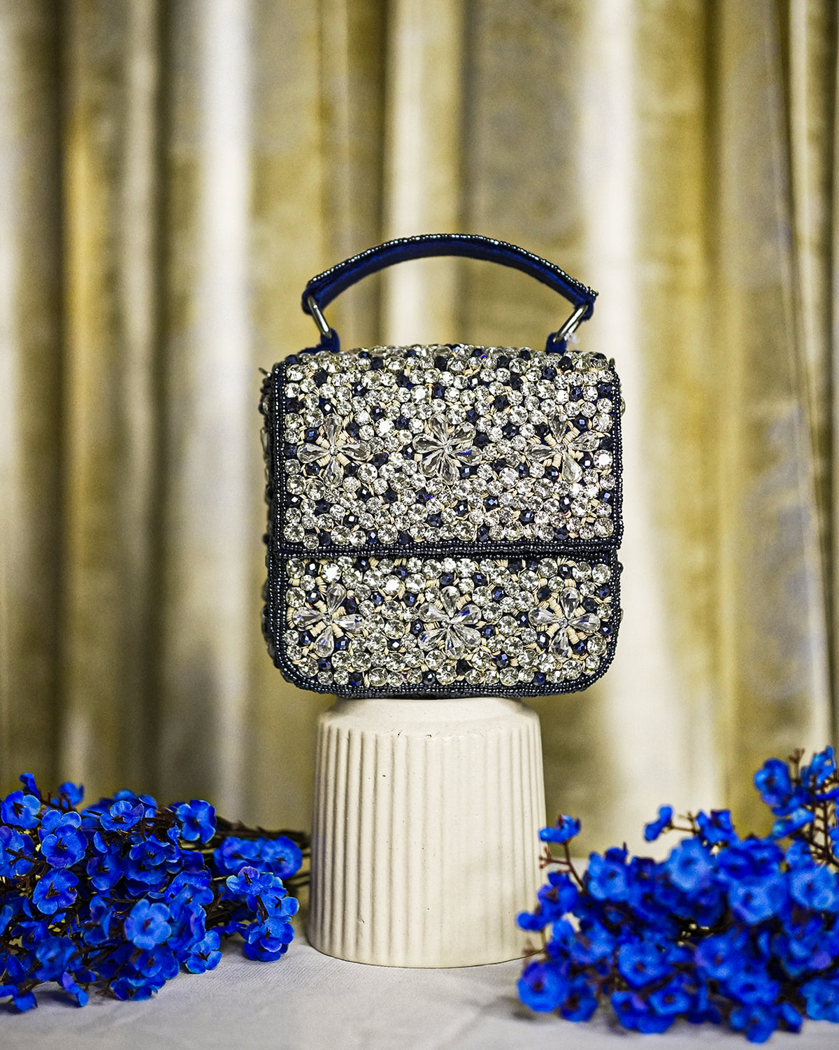 Blue crystal box bag with top handle and hinged clasp, sparkling rhinestone front panel