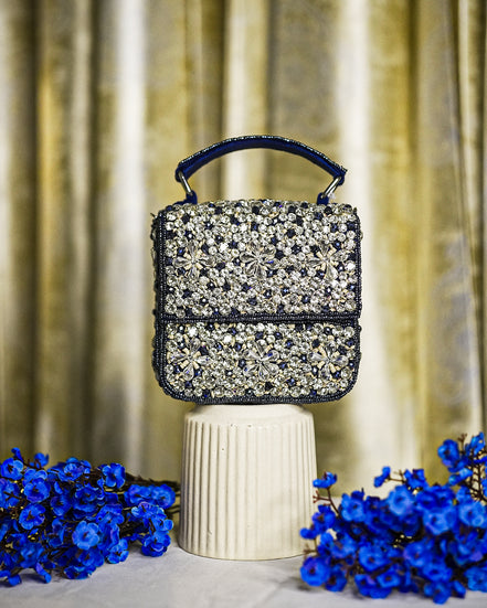 Blue crystal box bag with top handle and hinged clasp, sparkling rhinestone front panel