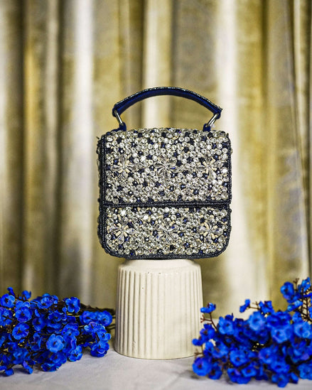 Blue crystal box bag with top handle and hinged clasp, sparkling rhinestone front panel