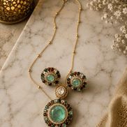 Gold-tone jewelry set with round stud earrings and large teal center circular pendant