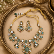 Gold-tone necklace and earrings set with green, white, pink and blue stone accents