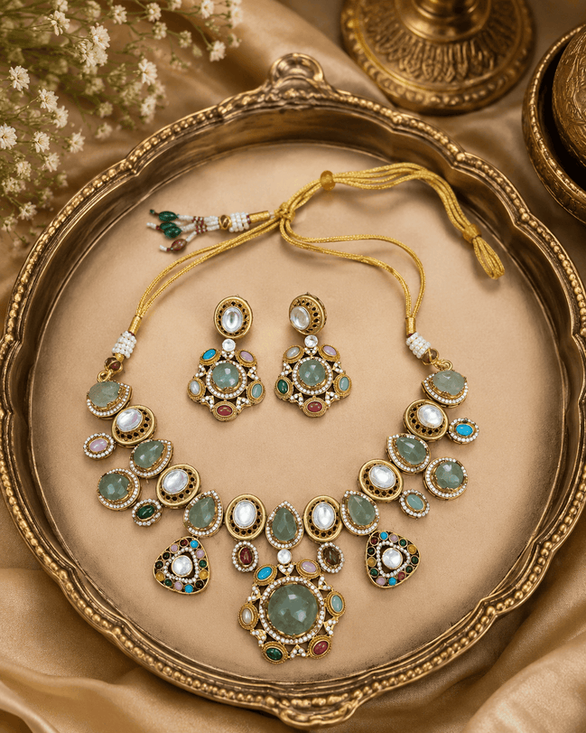 Gold-tone necklace and earrings set with green, white, pink and blue stone accents