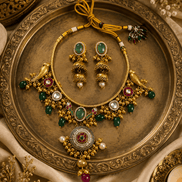 Gold-tone necklace and earrings set with round pendant and multicolor stones on tray