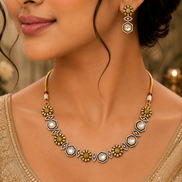 Gold-tone necklace with geometric white accents and matching drop earrings