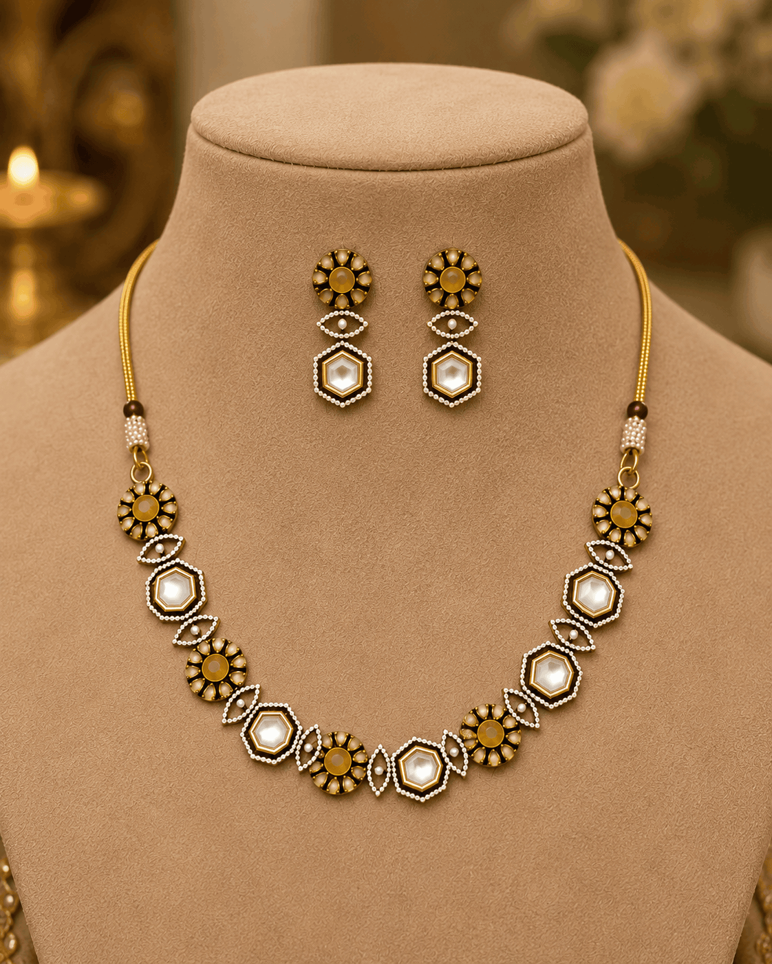 Gold-tone necklace set on mannequin with geometric pendant necklace and drop earrings