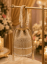 Beige beaded potli bag with tassel fringe, gathered drawstring and crystal drops.