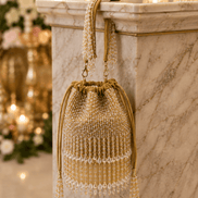 Beige beaded potli bag with drawstring and hanging tassels, crystal fringe.