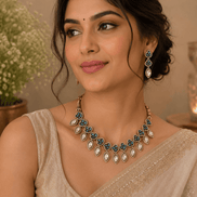 Teal and gold choker-style necklace with dangling drop earrings worn on model
