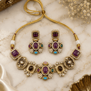 Beaded gold-tone necklace set with purple and teal stones; square stud drop earrings