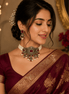 Wine choker necklace with pearl clusters and matching drop earrings on model