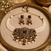 Wine-toned choker set with pearl drops and maroon gemstone center, gold-tone beads