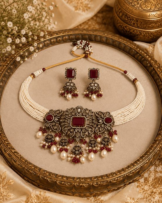 Wine-toned choker set with pearl drops and maroon gemstone center, gold-tone beads