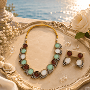 Beaded multicolor stone necklace with matching earrings on decorative tray