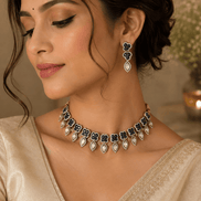 Teal and gold necklace with teardrop earrings worn on model