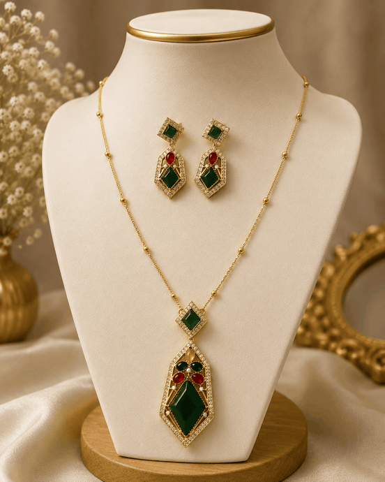 Gold-tone pendant necklace set with green center and red gemstone drop earrings
