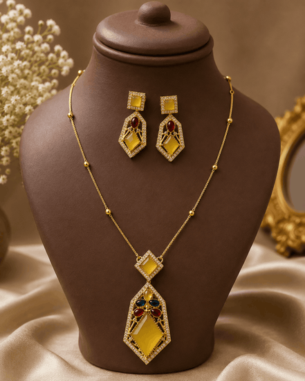 Gold-tone gemstone pendant necklace set with teal and red diamond pendant