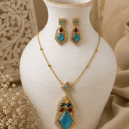 Gold-tone gemstone pendant necklace set with teal, green, and red earrings