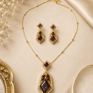 Gold-tone gemstone pendant necklace set with purple and green drop earrings