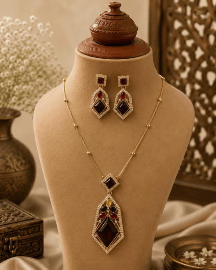 Gold-tone pendant necklace set with dark red, green, and purple gemstone drops