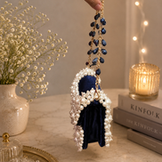 Pearl-beaded mini bag with navy fabric center and blue bead tassel chain