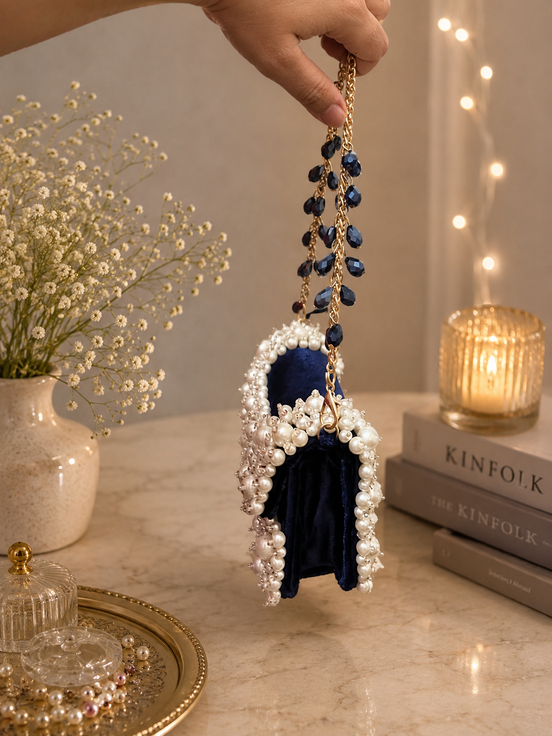 Pearl-beaded mini bag with navy fabric center and blue bead tassel chain