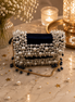Pearl-beaded mini bag with navy interior and gold chain strap