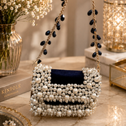 Pearl-beaded mini bag with scalloped top and long gold chain with blue drops