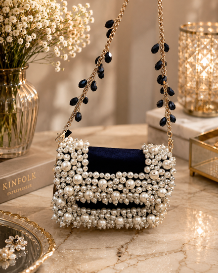 Pearl-beaded mini bag with scalloped top and long gold chain with blue drops