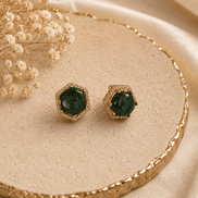 Gold-tone hexagon halo stud earrings with round dark-green gemstone