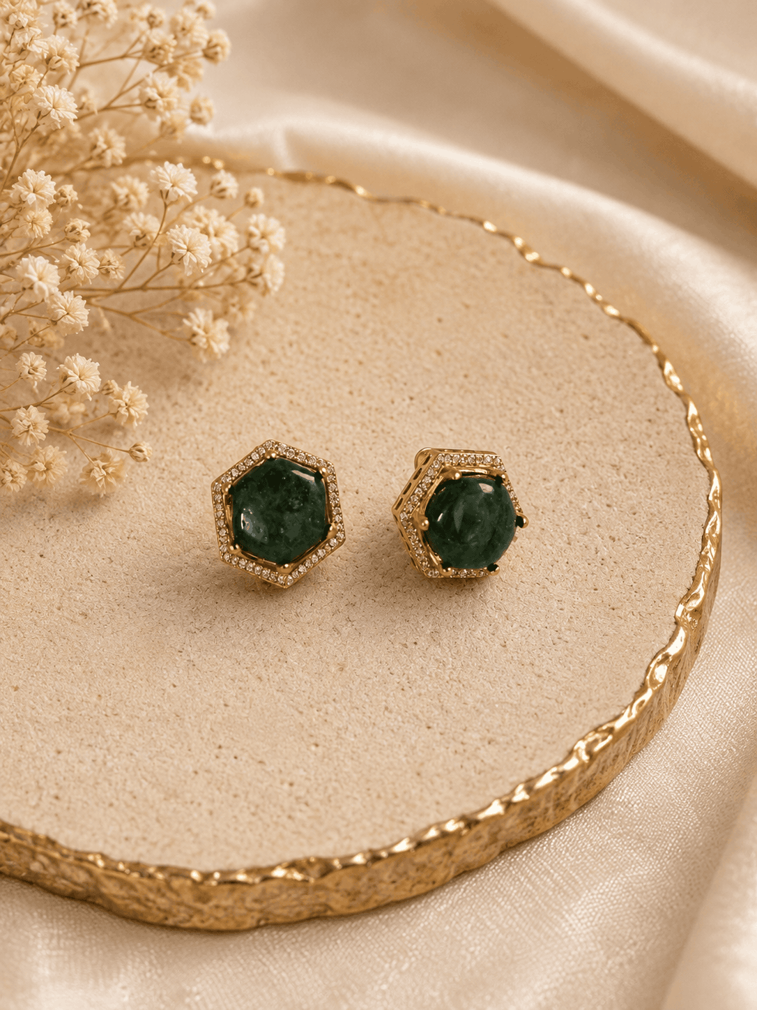 Gold-tone hexagon halo stud earrings with round dark-green gemstone
