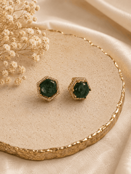 Gold-tone hexagon halo stud earrings with round dark-green gemstone