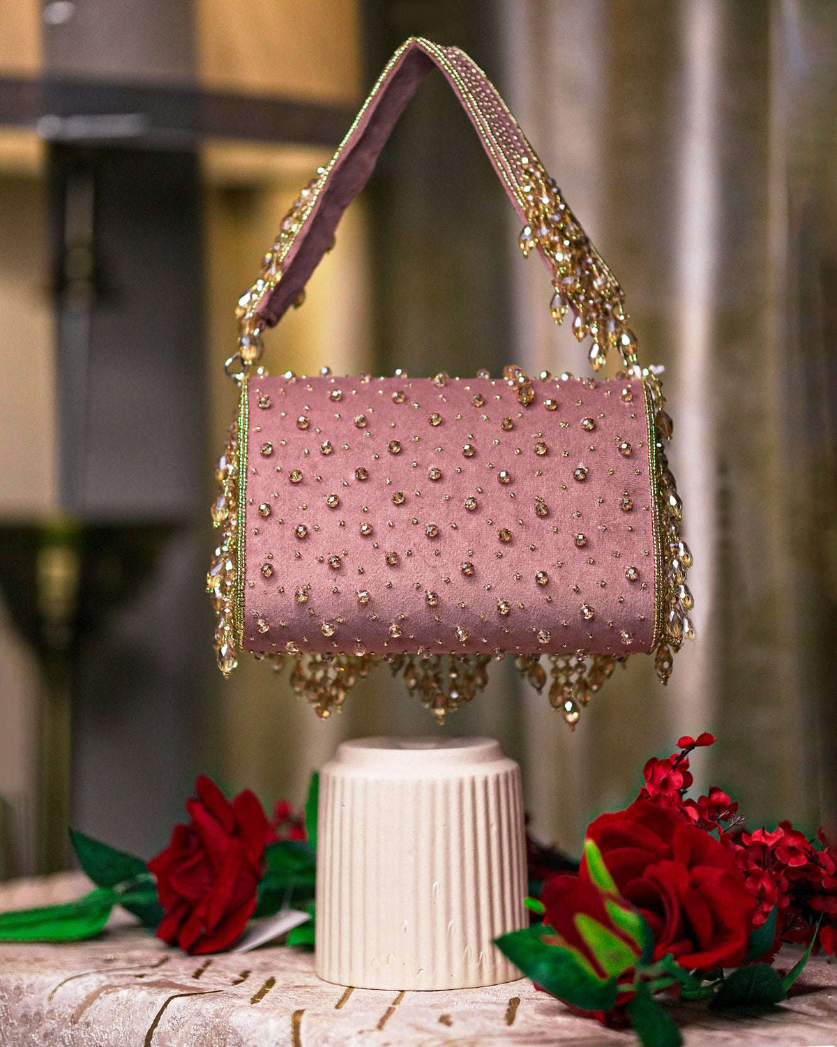 Pink beaded hobo bag with top handles and layered dangling fringe