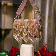 Pink crystal hobo bag with short handles and chandelier-style fringe