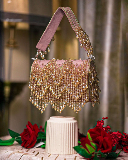 Pink crystal hobo bag with short handles and chandelier-style fringe