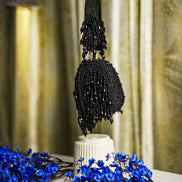 Black beaded hobo bag with vertical sequin texture and dangling fringe