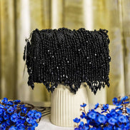 Black crystal hobo bag with scalloped fringe hem and bead-covered front