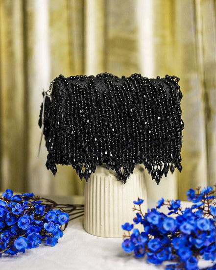 Black crystal hobo bag with scalloped fringe hem and bead-covered front