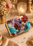 Floral clutch bag with multicolor print and gold-tone chain strap and clasp