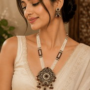 Women’s heritage necklace and matching drop earrings, ornate pendant with bead strands.
