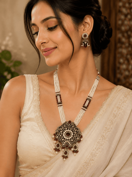 Women’s heritage necklace and matching drop earrings, ornate pendant with bead strands.