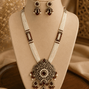 Gold-tone heritage necklace with large filigree pendant and matching stud-to-drop earrings.