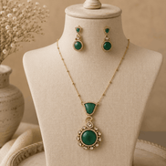 Emerald pendant necklace set with round teardrop centerpiece and matching drop earrings